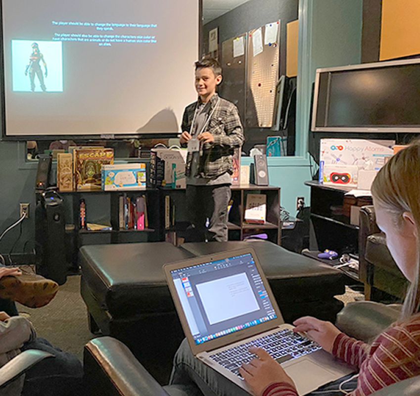 student giving presentation in front of screen